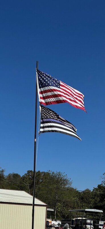 Old Glory and the Thin Blue Line Flags fly proudly over Blackburns Resort and Boat Rental. 